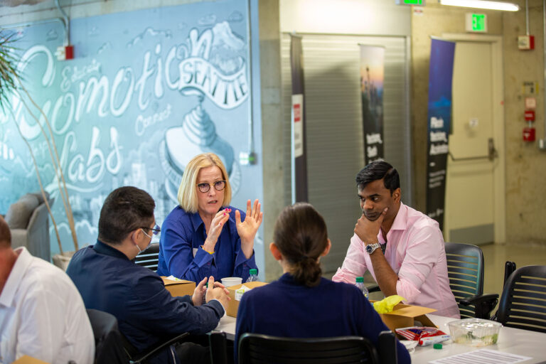 people engaged in discussion at Startup Hall