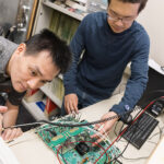 UW ECE graduate students Yi-Hsiang Huang (left) and Xichen Li (right) working in the lab of Professor Chris Rudell