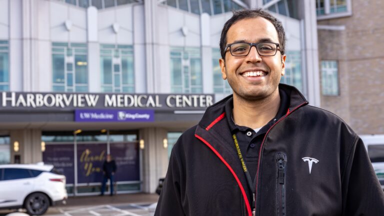 UW neuroscientist poses in front of Harborview Medical Center