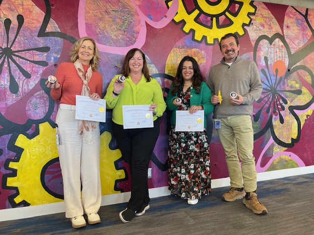 From left, CoMotion staff honorees Donna O'Neill, Lisa Norton, Venu Sareen, and Vice Provost for Innovation François Baneyx (standing in for absent honoree Debra Bouchegnies).