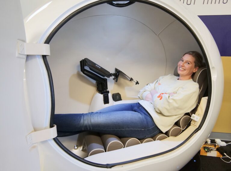CEO of Sanctum stretched out inside one of their private pods.