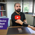 scientist demonstrating wearable device that uses body heat to power LED