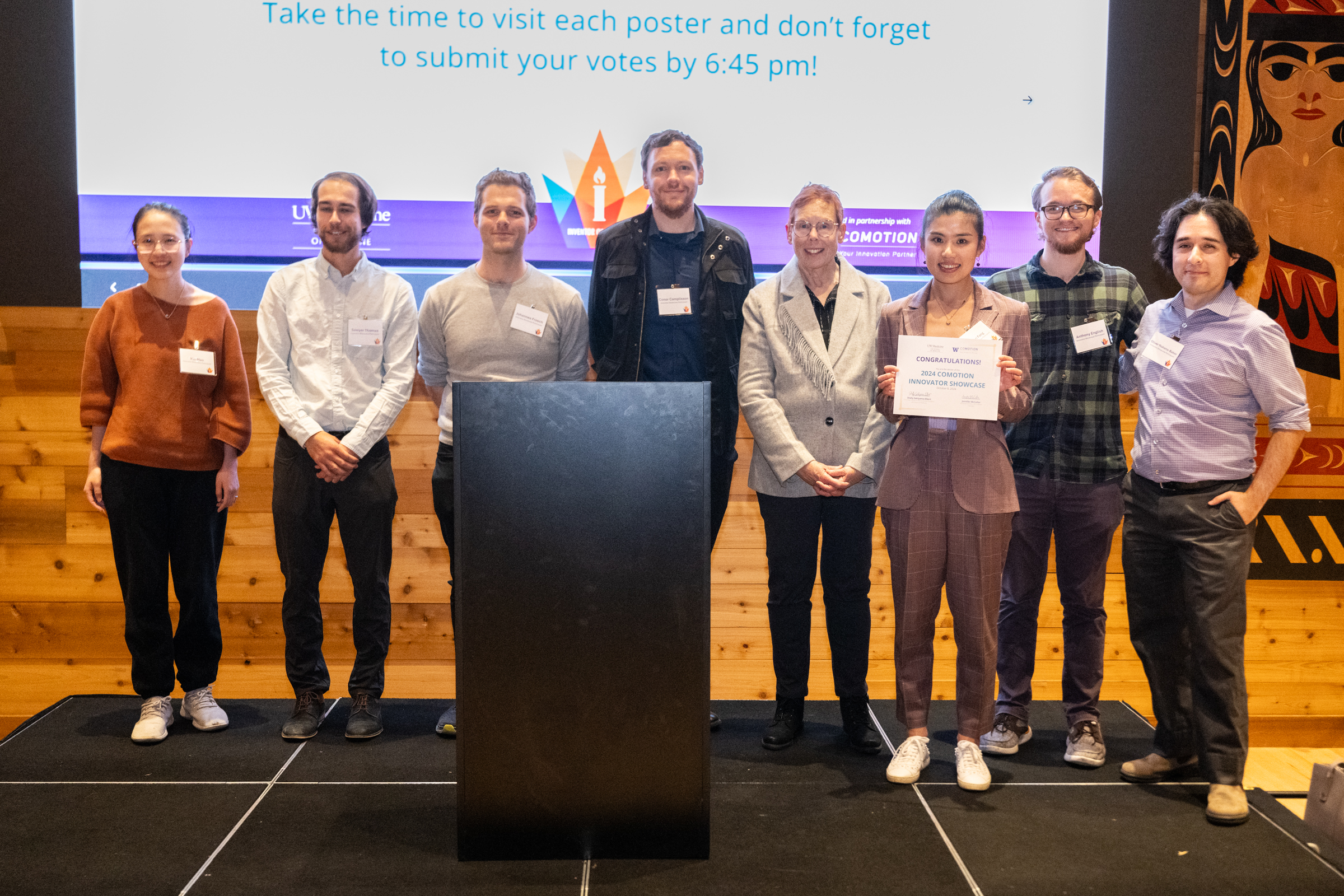 2024 UW Medicine Inventor of the Year honoree Nora Disis poses with researchers participating in the CoMotion Innovator Showcase.