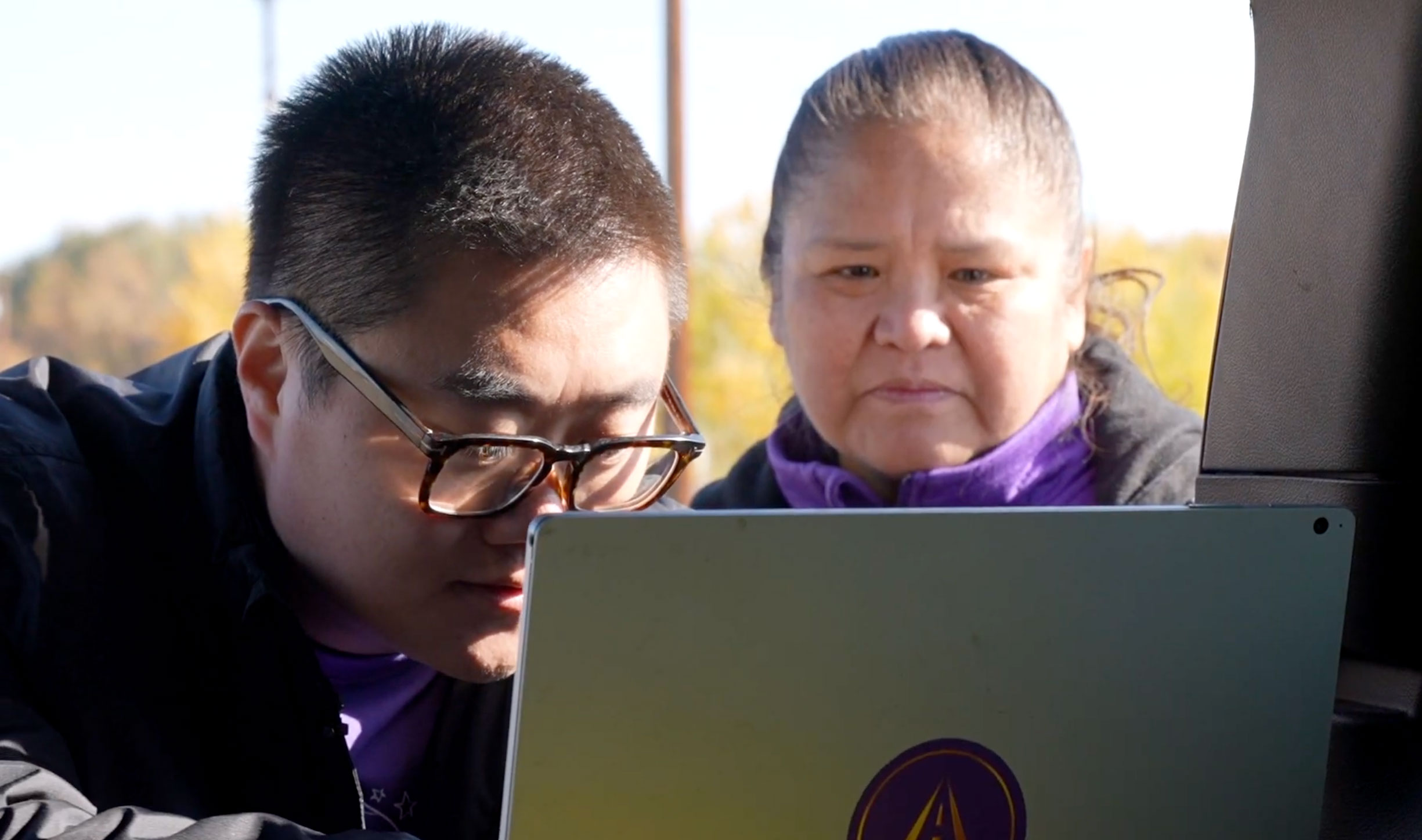 two people looking at computer