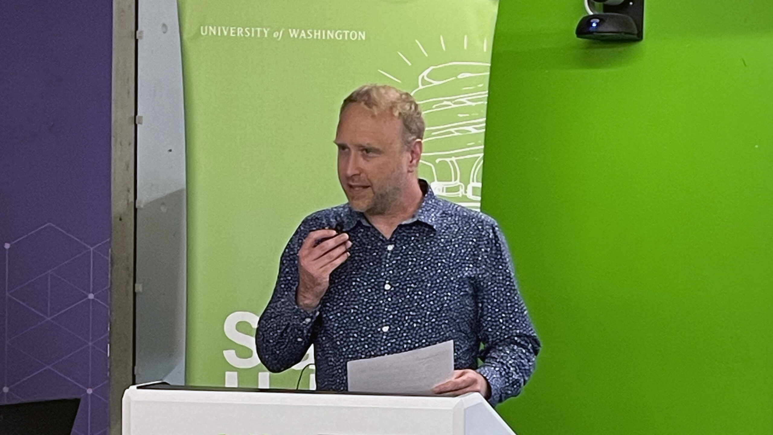 Ryan Buckmaster, CoMotion director of innovation investments, at the podium at Startup Hall.