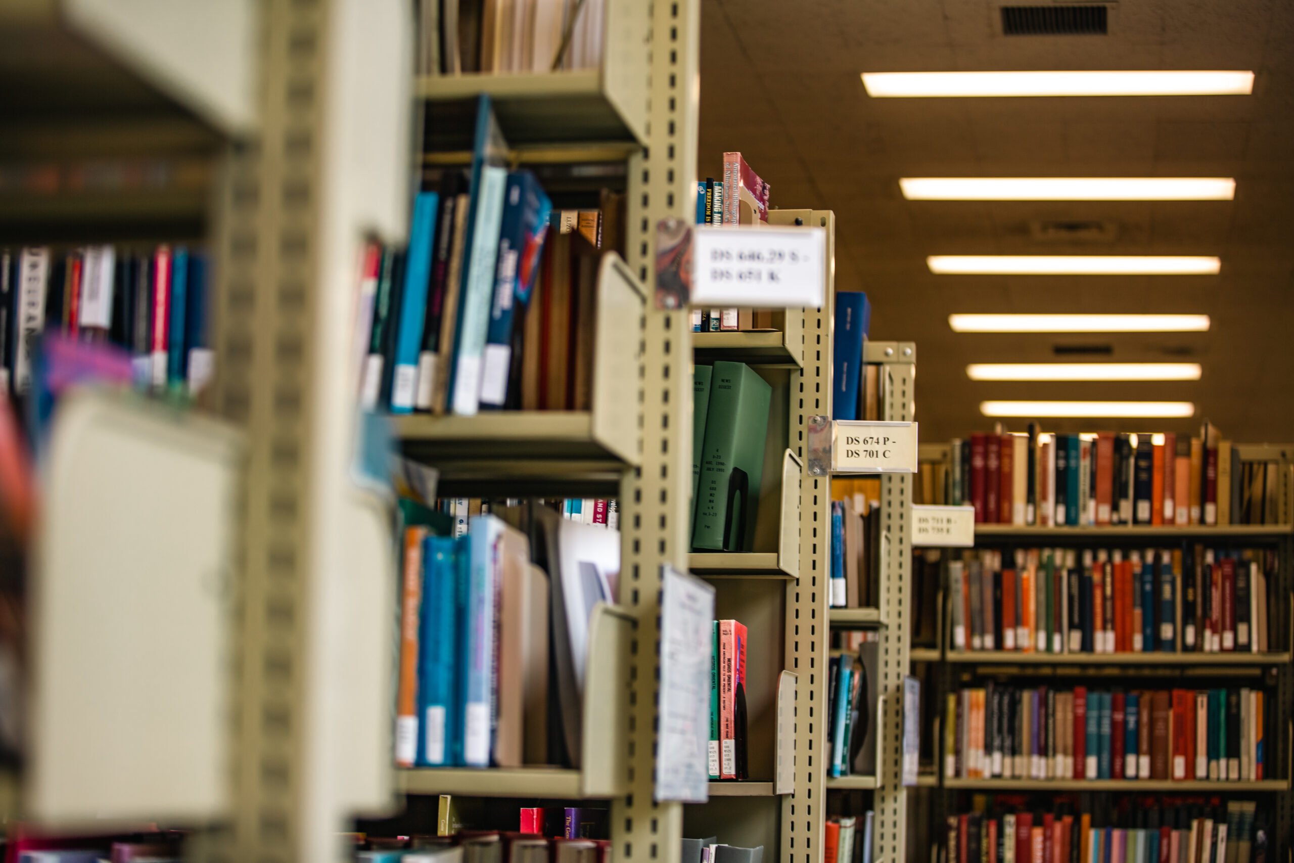 Rows of bookshelves filled with books inside a library
