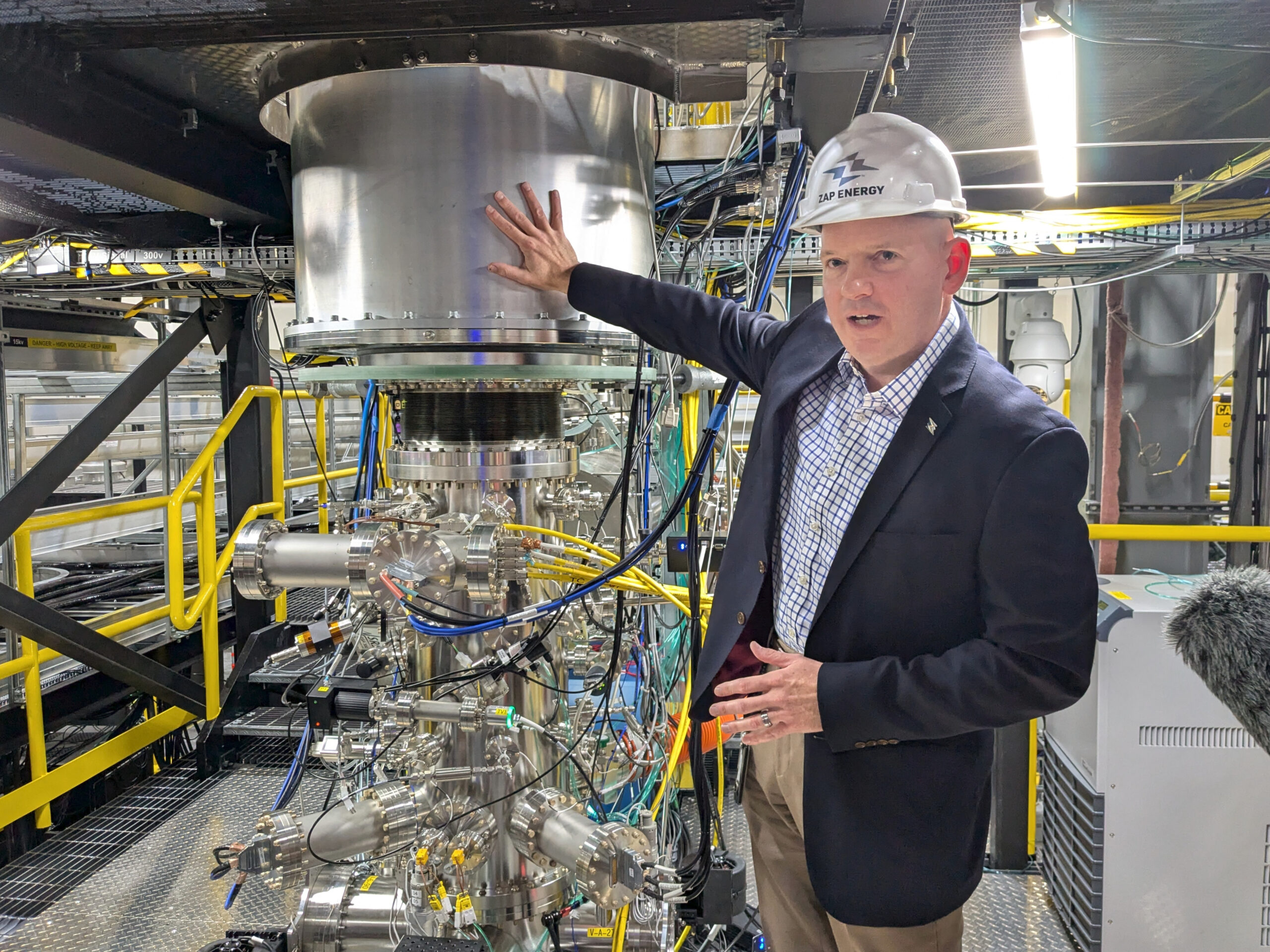 Matthew Thompson, Zap vice president of systems engineering, alongside a demo fusion reactors at the company’s Everett, Wash., research and development facility. (