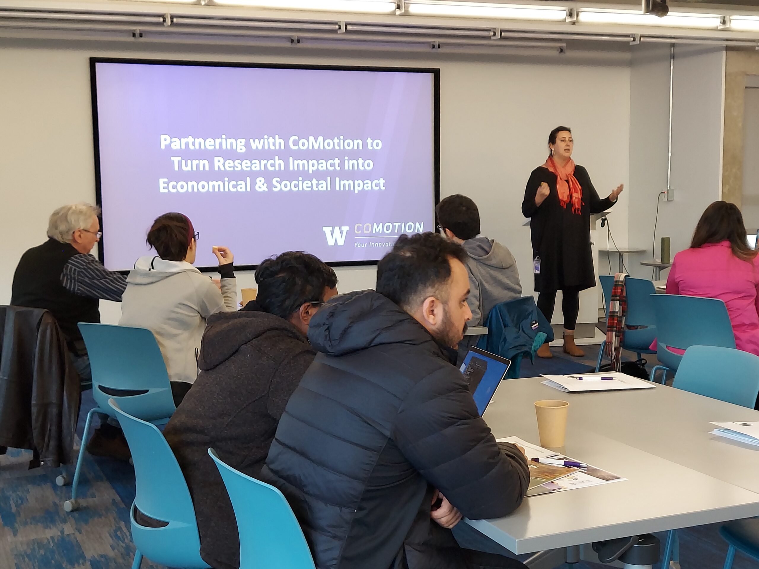 A presenter introducing an innovation training program to a group of attendees