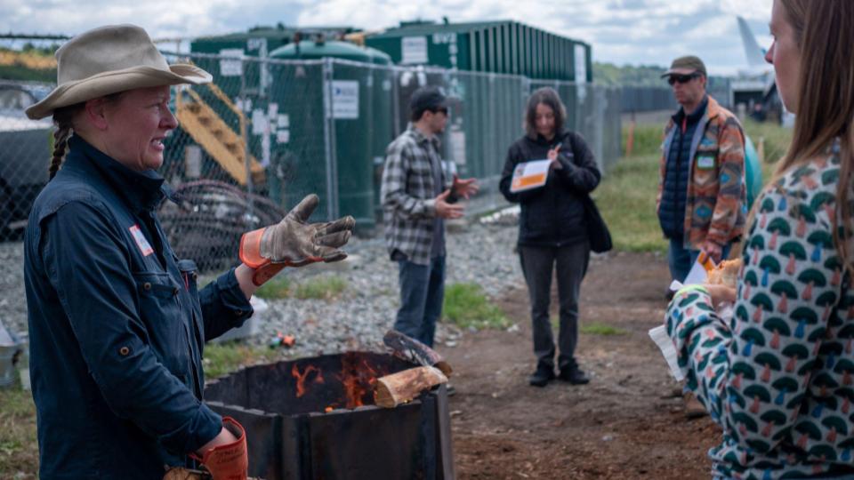 Korina Stark, Owner of FlameWise, teaches a biochar workshop and demonstration with their field-ready kiln. Photo by Ted Tarricone.